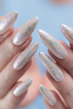 beautiful female hands with long nails light white manicureの写真素材