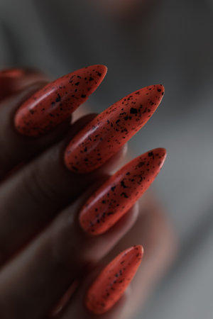 Hand with long nails and light orange neon manicureの写真素材