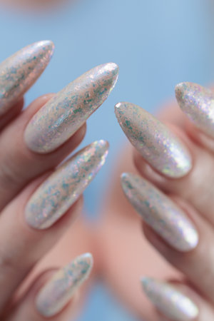 beautiful female hands with long nails light white manicureの写真素材