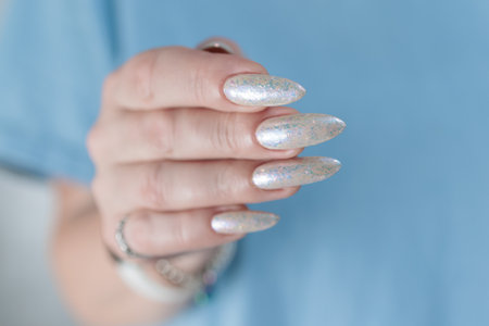 beautiful female hands with long nails light white manicureの写真素材