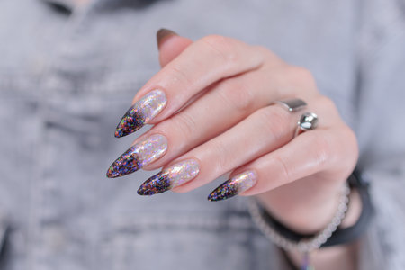 Female hands with long nails and white and black thermo French manicureの写真素材