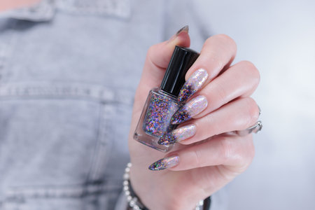 Woman's hands with long nails and white and black thermo manicureの写真素材
