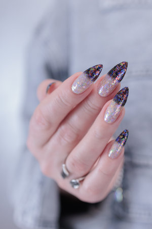 Female hands with long nails and white and black thermo French manicureの写真素材