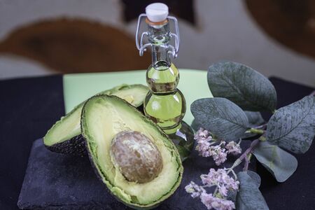 Avocado oil in decorative glass jar with stars background