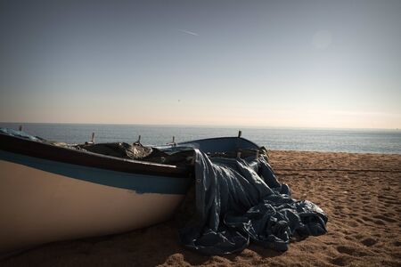Fishing boat on a beach in Cataloniaの写真素材
