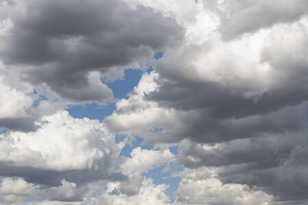 Fluffy and cottony white clouds over a blue sky