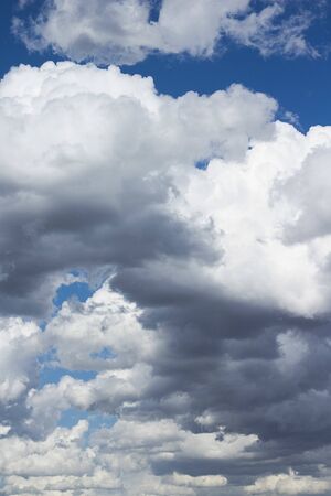 Fluffy and cottony white clouds over a blue sky