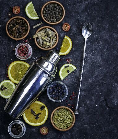 Ingredients for creating a cocktail and cocktail shaker on dark backgroundの写真素材