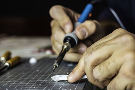 Close-up of a man's hands working with tools