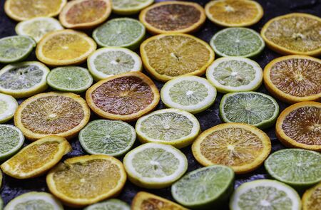 Citrus fruit sliced ?? on dark background creating a patternの写真素材
