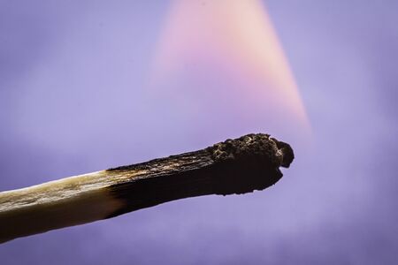 Match lit with a small flameの写真素材