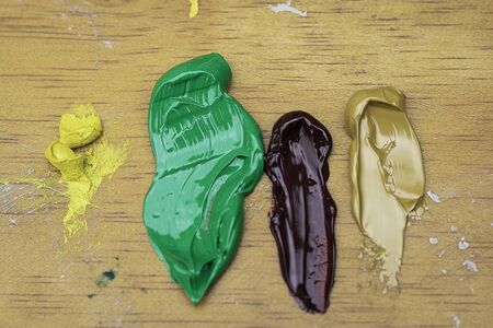 Colorful paint textures on wooden palette