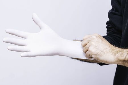 Putting on latex glove to prevent contagionの写真素材