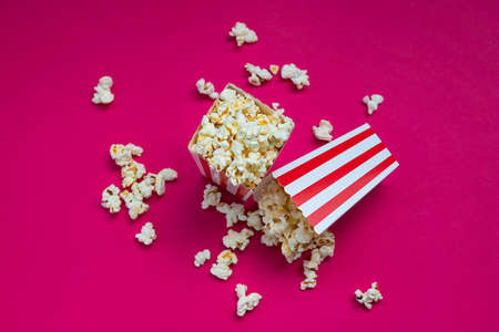 Overhead view of some popcorn on fuchsia background Conceptual cinema, filming, movies, feature filmsの写真素材