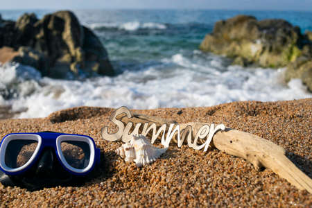 Cardboard letters with the word summer written with a beach in the background Conceptual of vacation, summer, sun and beach, tourismの写真素材