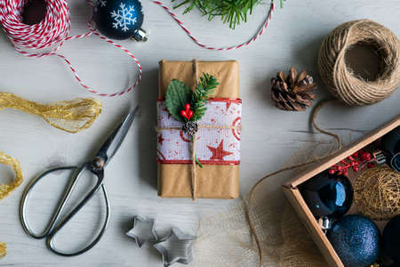 Still life of gift wrapped at home with Christmas objects Preparing Christmas gifts at home with...