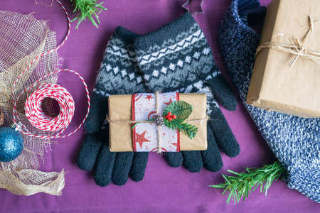 Still life of gift wrapped at home with Christmas objects Preparing Christmas gifts at home with scissors ribbons and twineの写真素材