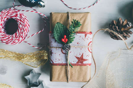 Still life of gift wrapped at home with Christmas objects Preparing Christmas gifts at home with...