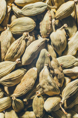 Green cardamom in grain Aromatic spice beans