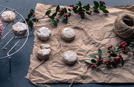 Artisan mantecados on brown paper and decorative red flowersの写真素材