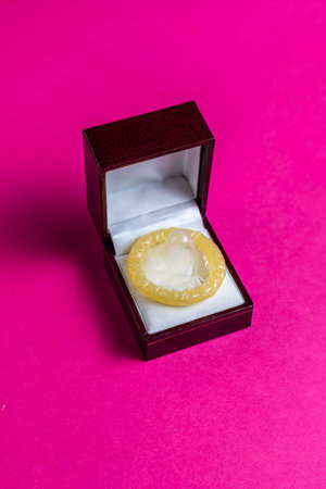 Condom in engagement ring boxの写真素材