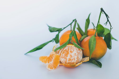 Fresh tangerines with leaves on white backgroundの写真素材