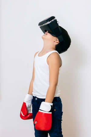 Boy with virtual reality glasses takes boxing lessons from a distanceの写真素材