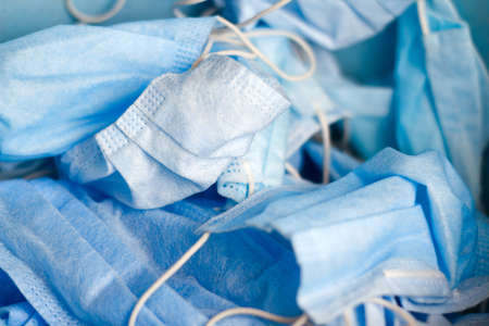 Close up lots of blue face masks on the background. The production of masks against the coronavirus...