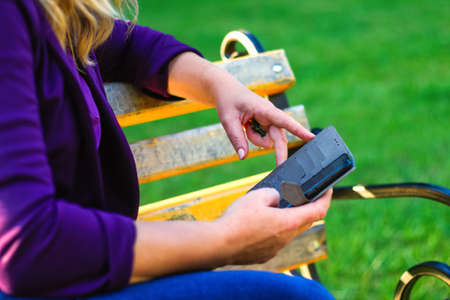Defocus caucasian blond woman talking, speaking on the phone outside, outdoor. 40s years old woman...