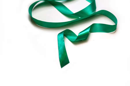 Defocus closeup Christmas tree made of green ribbon on white background. Minimal Christmas holiday background of curly tape. Xmas decor flat lay. Out of focus.の写真素材