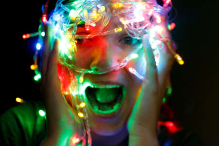 Woman is clutching her head in a panic. Stressed Christmas Girl Screaming. Young person having fun...