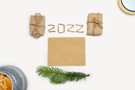 Blank eco card. Happy New year 2022. New Year Concept welcoming New Year 2022 written by craft rope or jute on white background. Two thousand twenty two. Eco gift boxes. Copy space. Flat layの写真素材