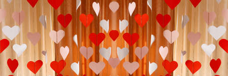 Defocus banner. Valentines Day background with paper hearts. The red and white heart shapes for 14...