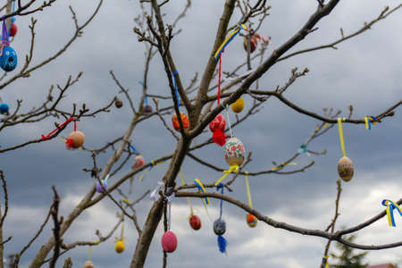 Many Easter eggs decorated outdoor. Handmade diy home exterior decoration with colorful easter eggs...