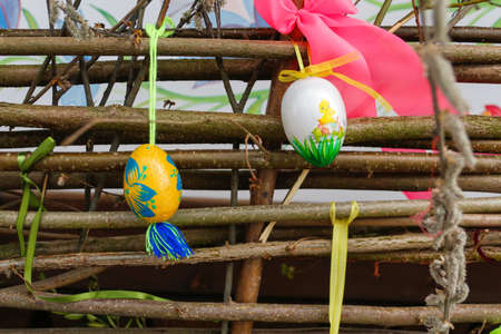 Easter eggs closeup. Handmade diy home exterior decoration with colorful easter eggs on wooden...
