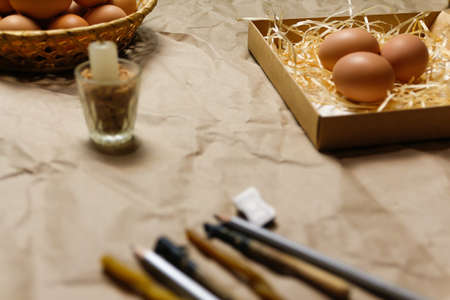 Tools for decorating Paschal eggs, Pysankas, with wax-resist dyeing technique. Collection of eggs. Homemade pen and melted beeswax for drawing of eggs. Ukraine. Preparation for Easter holiday.の写真素材