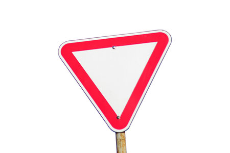 Red road sign isolated. Defocus blank empty triangle red warning road sign with blue sky background....