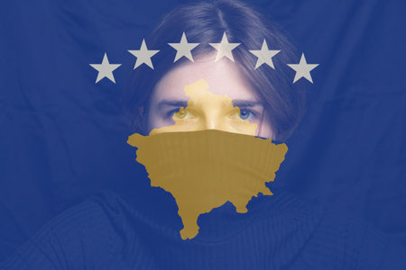 Defocus woman on Kosovo flag. Concept of border conflict, independence and freedom shipment or free trade agreement Conflict between Serbia and Kosovo. Out of focus.の写真素材