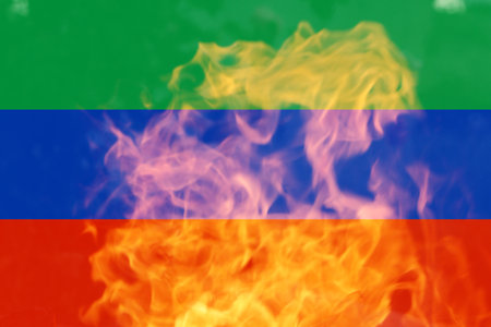 Defocus protest in Dagestan. Conflict war between Russia and Ukraine. North Caucasus force mobilization. Country flags on flame background. Out of focus.の写真素材
