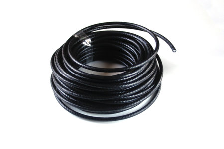 Defocus black rolled electric cable isolated on white. Electrical cable, energy and technology...