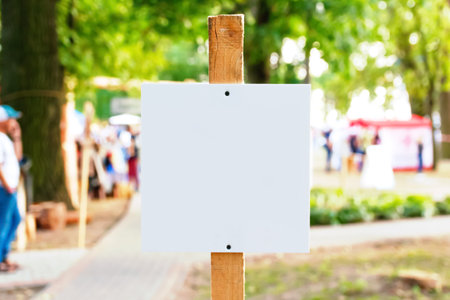 Defocus empty template, advertising mock-up, banner on grass near green park festival.Copy space for text. Information board on green background. Out of focus.の写真素材