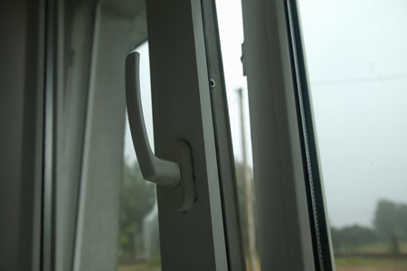 Open window in rainy weather. Cold winter weather. A wet window during rain. Out of focus.