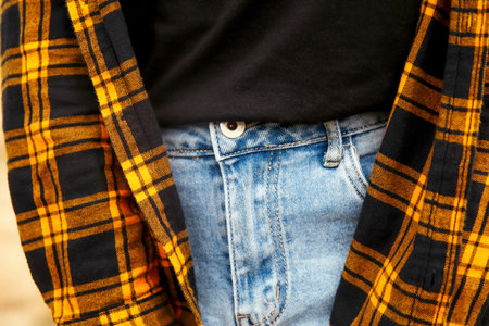 Hipster woman style. Millennial yellow and black checkered plaid shirt. Design. Fashion lifestyle. Casual clothes. Blue denim.の写真素材