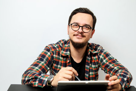 Young man with tablet. A young man using modern technology, digital lifestyle, business and...