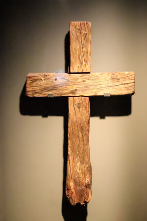 vertical image of an old, wooden cross. The photo, a powerful icon of Easter and love, is perfect for a religious or a spiritual theme.の写真素材
