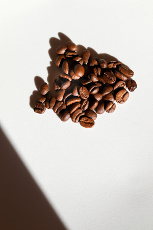 vertical image of coffee beans on a clean white background. coffee beans vertical white background. roasted coffee product shot.の写真素材