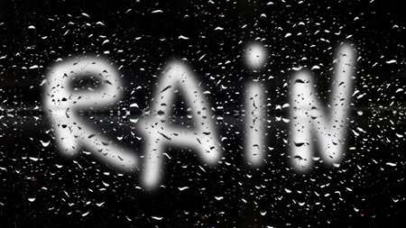 a single water drop or multiple rain drops beautifully isolated against a stark black background. rain drop water black background text overlay.の写真素材