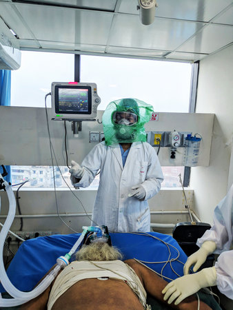 Dhaka, Bangladesh-3rd April 2020: Installing ventilation on patient in ICU of Impulse Hospital.のeditorial素材