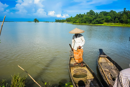 Sylhet, Bangladesh- 27th August 2014: Fisherman outing for fishing in Ratargul swamp forest by wooden boat.のeditorial素材