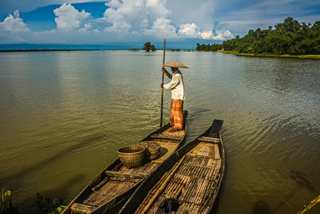 Sylhet, Bangladesh- 27th August 2014: Fisherman outs for fishing in Ratargul swamp forest by wooden boat.のeditorial素材